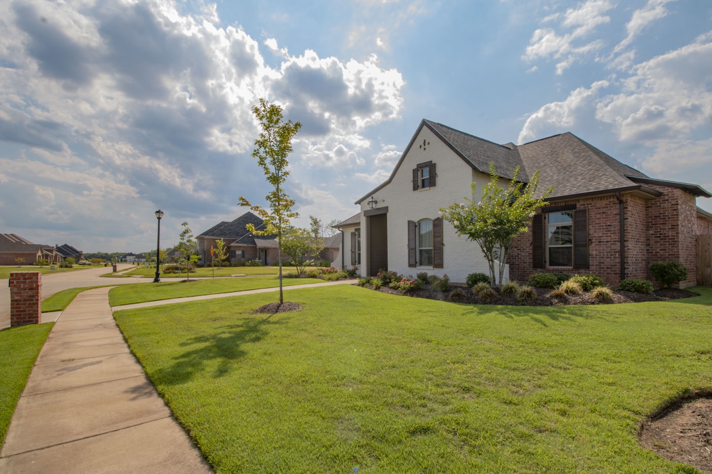 Neat suburban lawn along a curved sidewalk