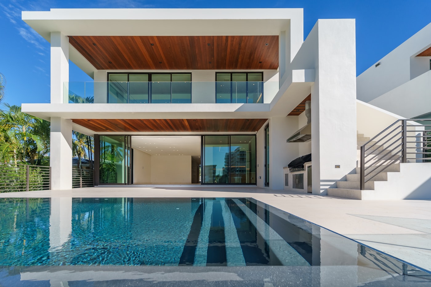 Modern villa terrace with pool and exterior staircase